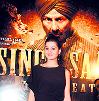 Anjali Abrol poses in front of a poster of Singh Saab The Great in Jammu on Sunday