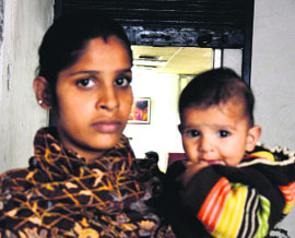 Simranjit Kaur, wife of accident victim Sukhwinder Singh, with her child in Ludhiana.