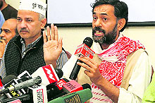 Aam Adami Party leaders Manish Sisodia (L) and Yogendra Singh Yadav at a press conference in New Delhi on Sunday