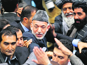 Afghan President Hamid Karzai leaves after the last day of the Loya Jirga, in Kabul on Sunday.