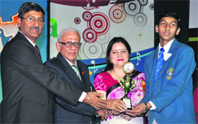 A student being presented an award during the annual award distribution ceremony at DAV International School in Amritsar.