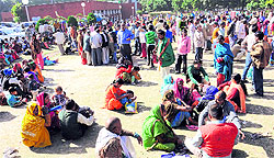 Evicted residents of Colony No. 5 outside the office of the Chandigarh Housing Board in Sector 9, Chandigarh, on Monday