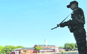 A security person stands guard at the Indian Military Academy in Dehradun on Monday.
