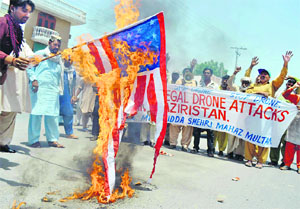 Pakistani protesters torch the US flag to voice their anger against the US drone attacks in Multan. A file photo by AFP
