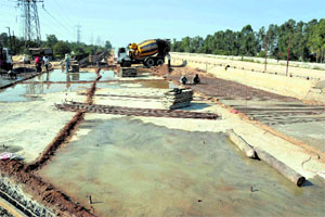 Work under way on the Sidhwan Canal bridge on Fereozepur Road in Ludhiana on Monday. 