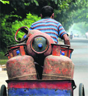 A man transports LPG cylinders in Ludhiana.