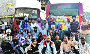 Drivers and conductors of Ludhiana City Bus Service Ltd hold a protest in Ludhiana on Monday