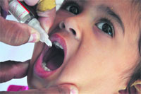 Polio drops being administered to a child at the railway station in Ludhiana on Monday