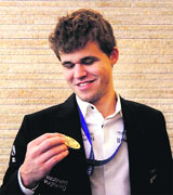 Gotcha: Norwegian Magnus Carlsen takes a look at his gold medal after the crowning ceremony in Chennai