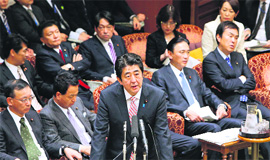 Japanese PM Shinzo Abe (C) answers a question at the National Diet in Tokyo on Monday.