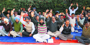 Members of the PUDA Employees Joint Action Committee stage a dharna in Bathinda on Tuesday.