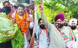 BJP candidate Pankaj Jain (L) and Congress candidate Tarvinder SIngh Marwah (R) with their supporters during the campaign in the Jangpura constituency in New Delhi on Tuesday. 