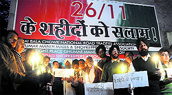 Shopkeepers of National Road hold a candlelight march in memory of the 26/11 victims, in Ludhiana on Tuesday