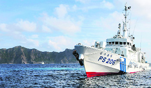 A Japanese Coast Guard vessel sails in front of the disputed Uotsuri island. 