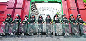 Riot police stand guard outside Parliament in Bangkok on Tuesday. 