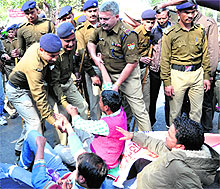 The police arrest striking contractual power employees in Dehradun on Wednesday