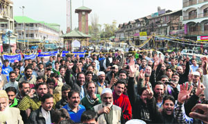 Members of the Kashmir Economic Alliance, a traders union, protest against the sealing of commercial complexes in Srinagar on Wednesday.