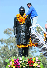 An activist pays homage to Congress stalwart Girdhari Lal Dogra on his 24th death anniversary in Jammu on Wednesday