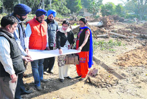 District Education Officer (Secondary) Paramjit Kaur Chahal looks at a map of the project at the school site in Ludhiana.