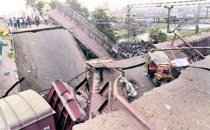 A portion of a flyover collapsed on a stationary goods train at Muzaffarpur in Bihar on Wednesday.