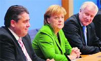 German Chancellor Angela Merkel (C) with her coalition partners in Berlin on Wednesday. AFP