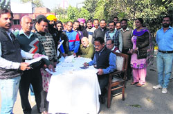 City residents at a counter set up for collection of property tax in Phagwara on Thursday. A Tribune Photograph 