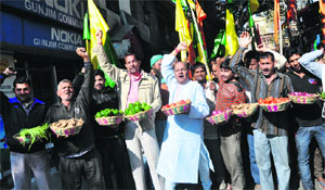 Members of the Shiv Sena hold a protest against the increase in the prices of vegetables in Jammu on Thursday. 