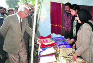 Governor NN Vohra looks at items displayed at the two-day employment fair in Reasi on Thursday.
