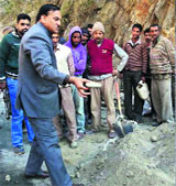 Congress MLA Ghulam Mohammad Saroori inspects the construction material for laying the Thathri-Kishtwar road in Kishtwar on Thursday
