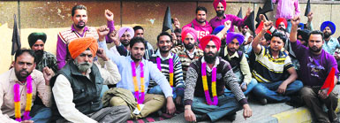 Employees of the city bus service begin a chain hunger strike in support of their demands in Ludhiana on Thursday. Photo: Inderjeet Verma