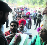 Residents stand in a queue to deposit property tax at the Zone D office of the MC in Ludhiana. Tribune Photo: Himanshu Mahajan