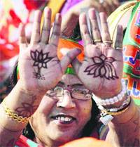 A woman supporter shows BJP symbol on her palms at Narendra Modi's election rally in Sikar on Thursday