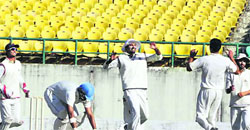 Rishi Dhawan (right) celebrates the fall of a wicket.  Kamaljeet