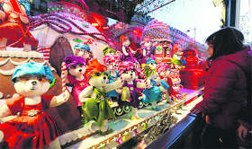 A girl stands in front of an animated Christmas window in Paris on Wednesday.