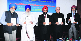 Joginder Singh Vedanti (2nd from left), former Jathedar, Akal Takhat Sahib, releases a book at the GNDU in Amritsar on Friday.