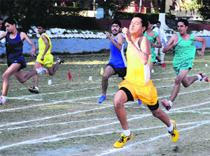 in full flow: Welham School boys take part in 100-metre sprint during the sports meet in Welham Boys School in Dehradun on Friday. 