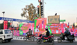 Leaders and supporters of the BJP put up hoardings at Satwari Chowk to welcome the BJPs prime ministerial candidate Narendra Modi in Jammu