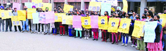 Members of the Sarv Shiksha Abhiyaan and Non-Teaching Employees Union hold a protest wearing black strips on their mouths in front of the Deputy Commissioner's office in Sangrur on Friday. A Tribune photograph
