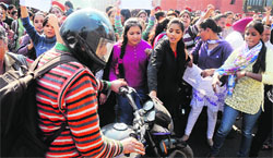 College girls hold a protest near CMC Hospital, Ludhiana, on Friday. Tribune photo: Himanshu Mahajan