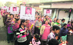Family members of Vidhu Jain and residents take out a candlelight march against police inaction in the murder case in Malerkotla on Thursday. a Tribune photograph