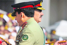 Pakistans outgoing army chief General Ashfaq Kayani (front) walks past his successor General Raheel Sharif in Rawalpindi on Friday.