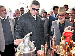 Chief Minister Omar Abdullah looks at items displayed at a handicrafts mela in Srinagar on Saturday