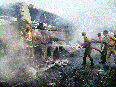 Firefighters dousing the flames that engulfed the luxury bus which caught fire at Mahboobnagar in Andhra Pradesh. The private bus was on its way from Bangalore to Hyderabad.
