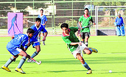 Hockey players from Himachal Pradesh and Karnataka fight for the ball during the 59th National School Games in Bathinda on Sunday