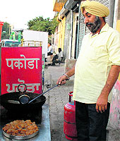 Narender Singh prepares fish pakoras at his outlet on Ajit Road in Bathinda