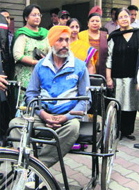 A beneficiary with his tricycle in Chandigarh on Sunday.