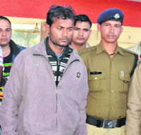 Jitendra Chauhan, accused of murdering a student of Graphic Era University, in police custody in Dehradun on Sunday.