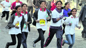 Girls take part in a marathon organised by the IMA Blood Bank on World AIDS Day in Dehradun on Sunday
