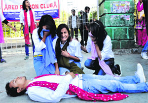 Members of the Red Ribbon Club perform a street play on AIDS at Gandhi Park in Dehradun on Sunday.