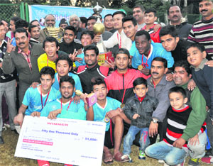 Players celebrate after winning the Drona College 70th Nemidas Memorial District Football League in Dehradun on Sunday.